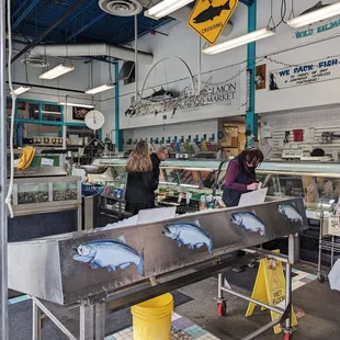 View looking in, fresh fish on ice, clams etc in tanks, and fresh fish in display case