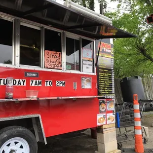 a red food truck parked on the side of the road
