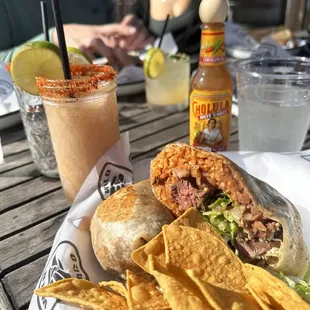 a plate of food with chips and a drink