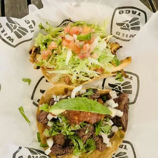 two tacos with lettuce and tomatoes