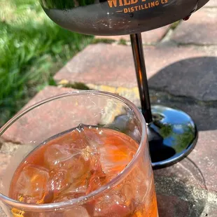 a drink in a glass with a cherry on top