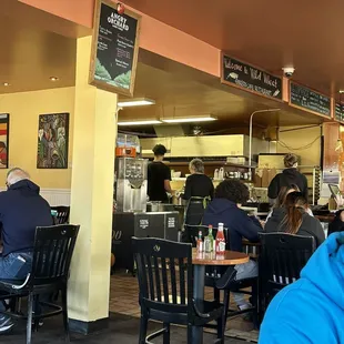 people sitting at tables in a restaurant