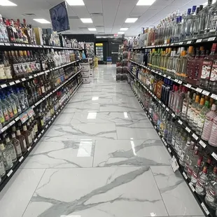 a wide aisle of liquor bottles