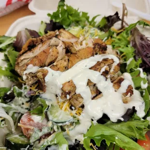 a plate of salad with dressing