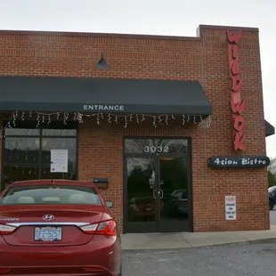 people standing outside of a restaurant