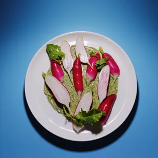 a plate of radishes on a blue background