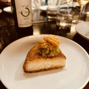 a piece of fish on a white plate