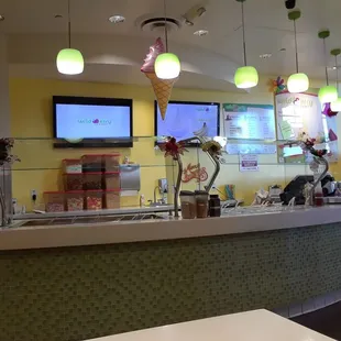 the inside of a restaurant with a counter