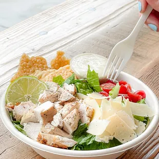 a person eating a salad with a fork
