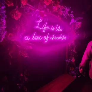 a neon sign that says life is like a box of chocolate