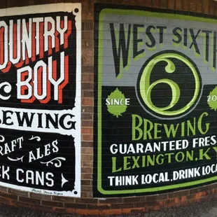 Hand painted advertisements by a local artist for local beer companies