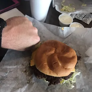 a hamburger and fries on wax paper