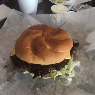 a hamburger on a piece of wax paper