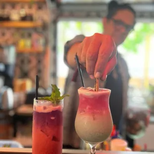Bartender finishing up our cocktails