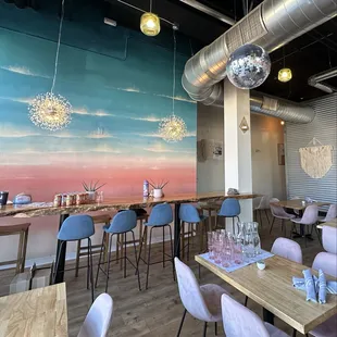 a dining area with tables and chairs