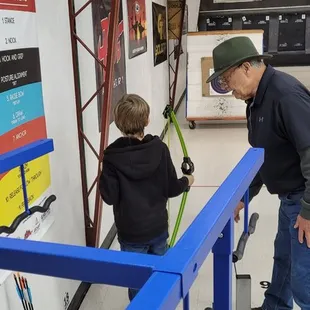 Bruce teaching my grandson how to shoot a bow