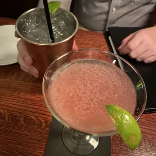 a close up of two cocktails