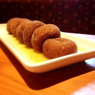 Donuts served warm with maple bourbon sauce and dusted with cinnamon anise sugar.