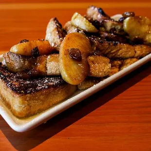 Thick sliced French Toast with local apples, golden raisins, and bourbon caramel sauce.