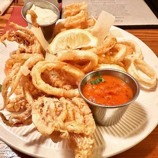 a plate of deep fried squids with dipping sauce