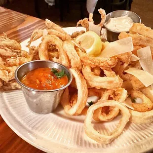 a plate of deep fried squid rings and dipping sauce