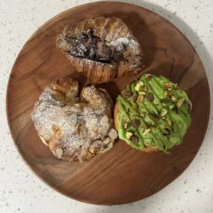 Almond croissant, chocolate cookie croissant, pistachio cinnamon roll.