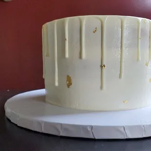 a white cake with gold drips