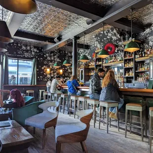 people sitting at the bar in a restaurant