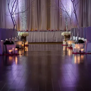a wedding set up with candles and flowers