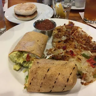 Breakfast burrito with onions peppers, crispy hash browns on the side, really good