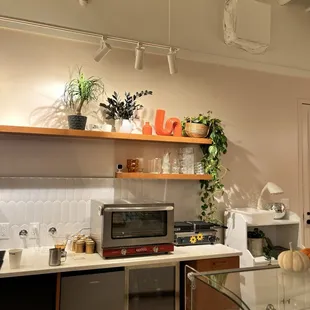 a kitchen with a counter and shelves