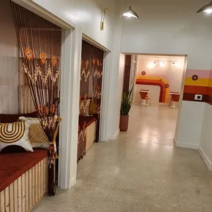 a hallway with a bench and curtains