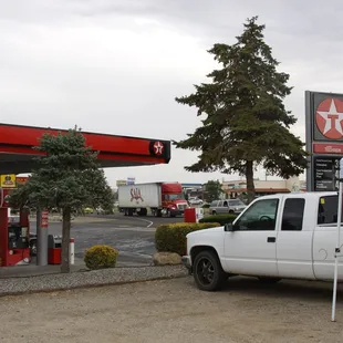 a truck parked in front of a gas station