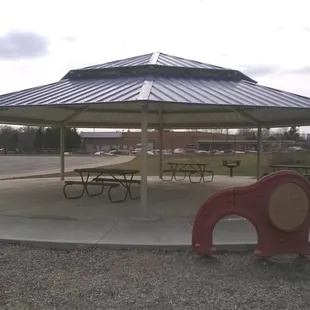 nice shelter and grill near the parking lot and playground