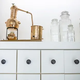 a copper coffee grinder on top of a dresser