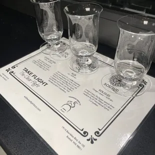 three glasses and a menu