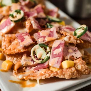 Ahi Nachos - Wonton wrapper, fried crispy with grilled tuna, mozzarella, mango, pico, jalapenos, and honey sriracha.
