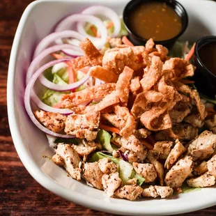 Crunchy Zen Salad - Fresh greens, cabbage, carrots, red onion, crispy wonton strips with Asian Sesame Dressing. Grilled chicken added.