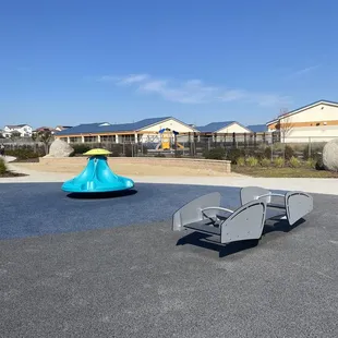 Seesaw, merry-go-round, sandpit in the background