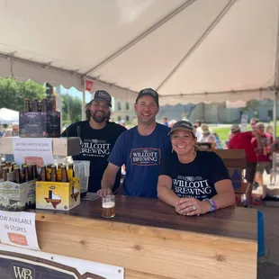 two men standing behind a bar