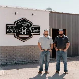 two men standing outside