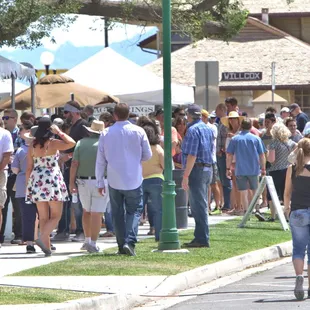 a large crowd of people walking down a street