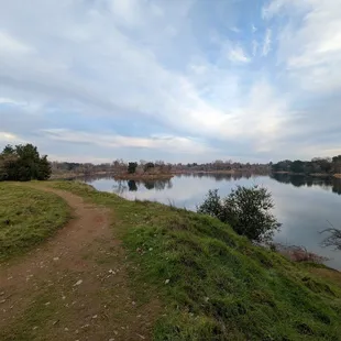 There are plenty of unpaved paths that follow the river and lead down to it.