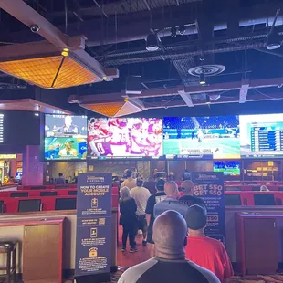 One person working the sports book with a line out the door 8:32am