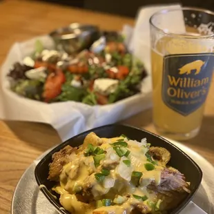 Cajun nachos with beer cheese. In the back the caprese salad