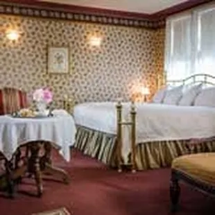 The Butler's Cottage Suite features a fireplace, double whirlpool tub, private bath, brass King bed.
