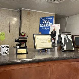 a counter with framed photos and plaques