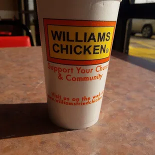 a cup of chicken on a table