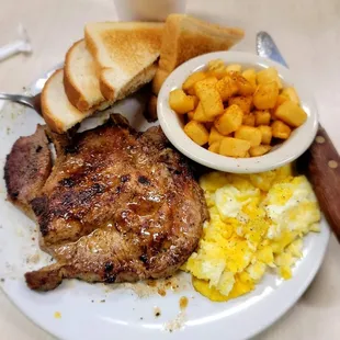 Grilled pork chop, eggs, potatoes