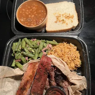 2 meat with 2 sides on a kids plate. The dirty rice was more of a Spanish rice with 2 baby ribs and Cajun green beans with baked beans.